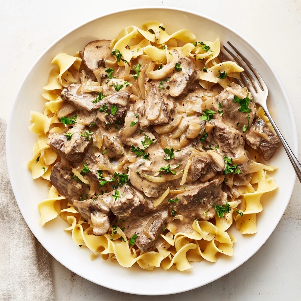 Tender beef stroganoff served over egg noodles with creamy mushroom sauce.  