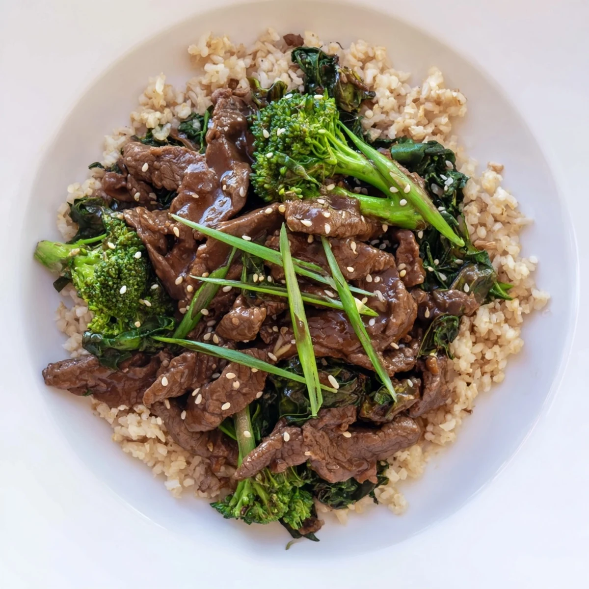 A bowl of hearty Slow-Cooker Beef & Broccoli, garnished with scallions, perfect for a cozy weeknight dinner.