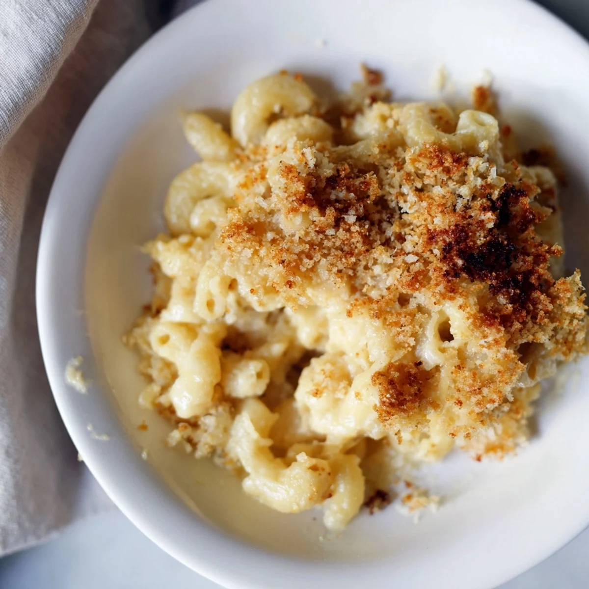 Steaming hot Baked Macaroni and Cheese, served in a casserole dish, a perfect comfort food classic.