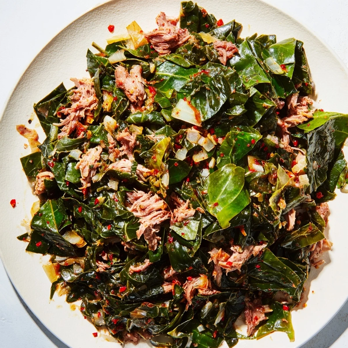Steaming Southern-style collard greens with tender smoked turkey, a vibrant and savory side dish.