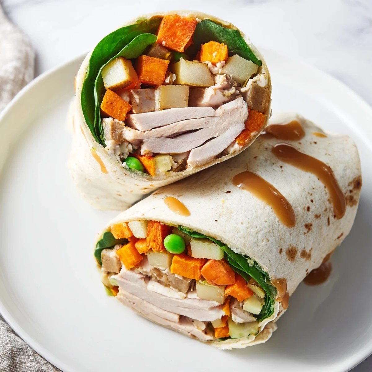 Simple Christmas Leftover Wrap Hack, filled with colorful turkey, stuffing and veggies on a plate.