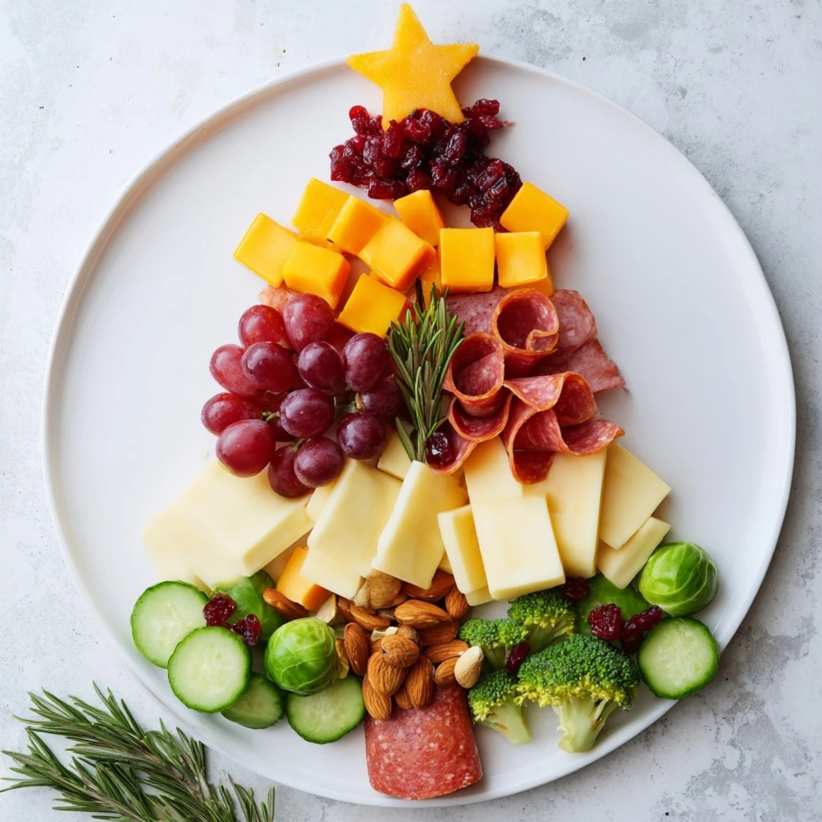 Festive Evergreen Tree Snack Board boasts colorful fruits, cheeses, and charcuterie perfect for a holiday appetizer.