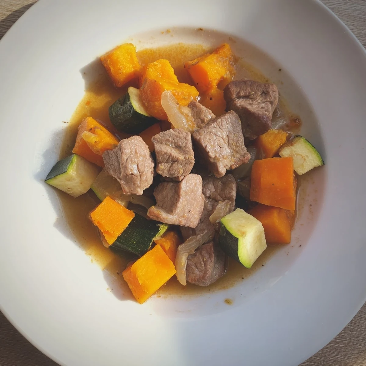 Golden cubes of lamb and veggies simmered in broth, ready for a delicious Sweet Lamb Platter.