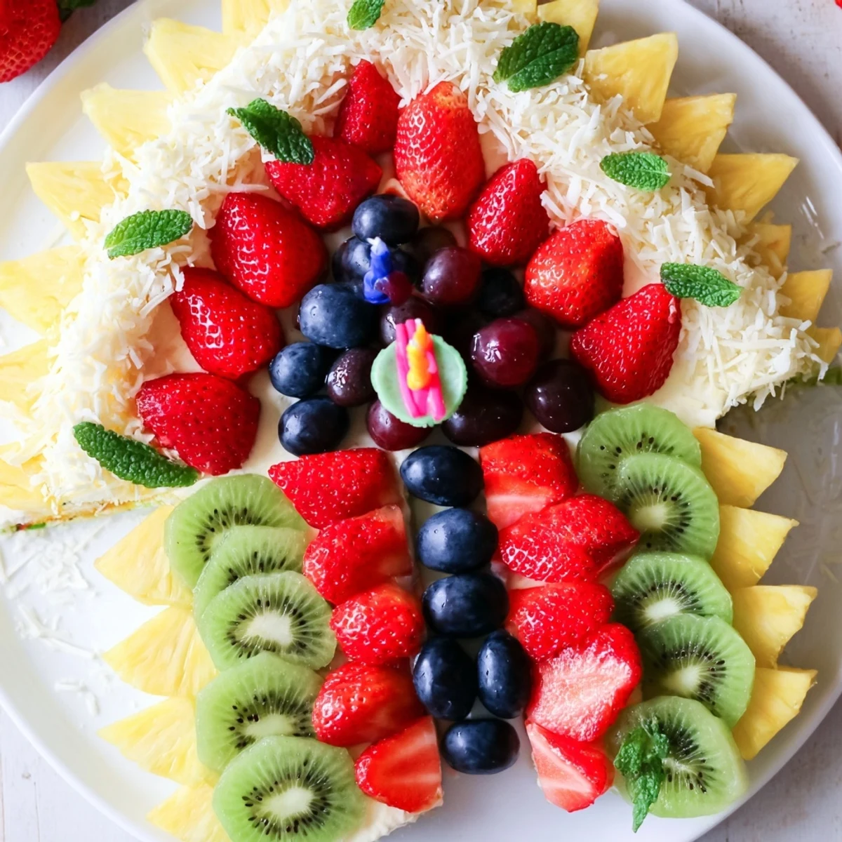 A vibrant Birthday Board: Cake Slice Fruit Platter, layered with colorful fruit slices and berries.