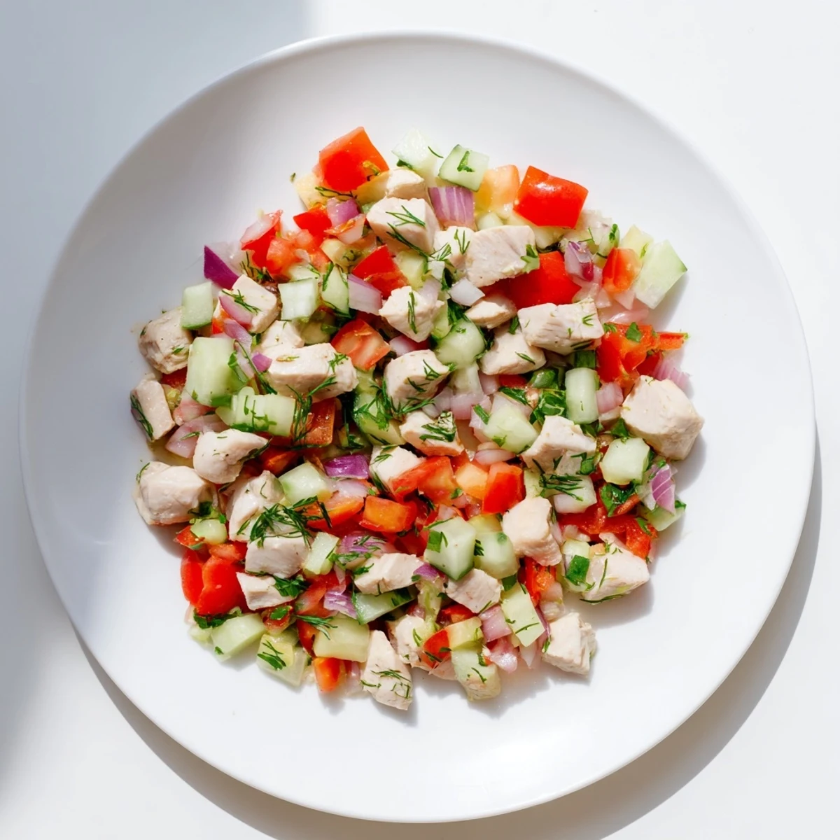 A bowl of fresh Cucumber and Chicken Clean Shaker, packed with colorful veggies and lean chicken, ready to eat.
