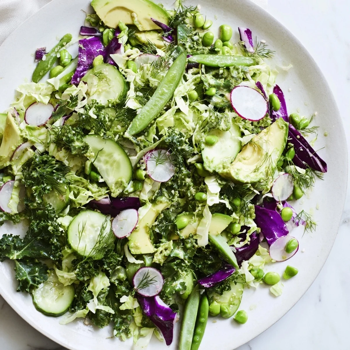 A colorful bowl of Green Goddess Detox Cabbage Salad with crisp veggies and vibrant dressing.