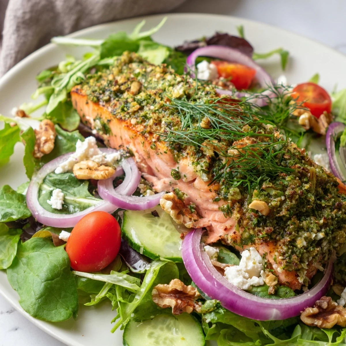 Herb-Crusted Salmon Salad, a luscious salmon fillet atop vibrant greens, ready to enjoy.