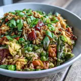 Colorful veggie-packed fried rice featuring crisp spring peas, carrots, and green onions, perfect as a quick, nourishing main dish.  
