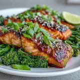 Succulent salmon fillets roasted with honey soy glaze, accompanied by sesame oil-tossed broccoli for a flavorful Asian-inspired meal.  
