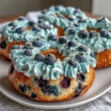 Delicious Blueberry Burst Protein Bagels with creamy Greek yogurt frosting, perfect for a healthy breakfast or snack.  