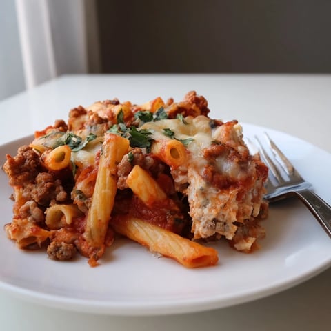 Baked Ziti with Sausage and Mozzarella, topped with gooey cheese and rich sauce.  