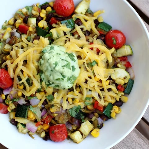 Steaming Veggie-Packed Taco Skillet with Avocado Yogurt presented visually with colorful vegetables and creamy sauce.