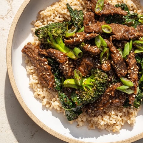 Tender Slow-Cooker Beef & Broccoli with a savory sauce, served over fluffy, nutty brown rice and greens.