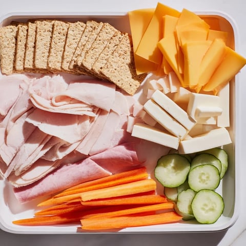 DIY Lunchables Tray featuring colorful kid-friendly ingredients like cheese and crackers make a great snack.