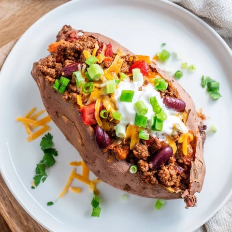 Smoky chili piled high in baked sweet potatoes, ready to be enjoyed as a hearty meal.