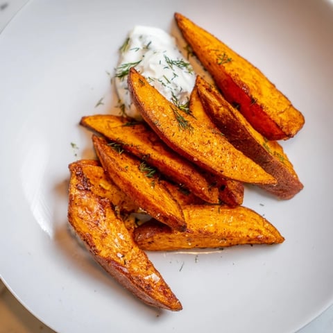 Golden brown, crispy roasted sweet potato wedges served with creamy yogurt dip.