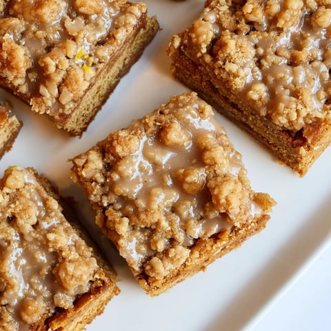 Golden, spiced Lemon-Glazed Gingerbread Crumble Bars, drizzled with bright lemon glaze, ready to serve.