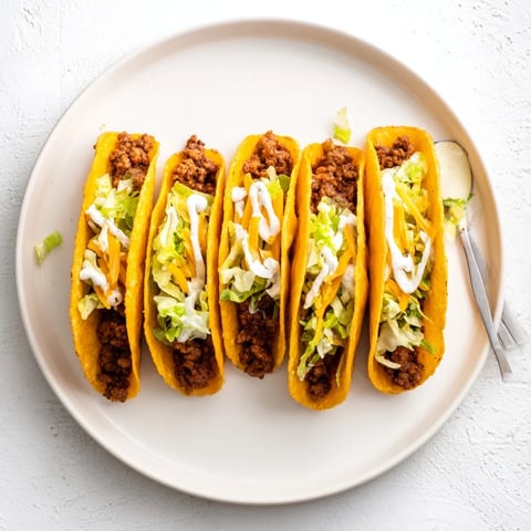 A close-up of a delicious Cheesy Gordita Crunch taco loaded with beef, cheese, and fresh lettuce.