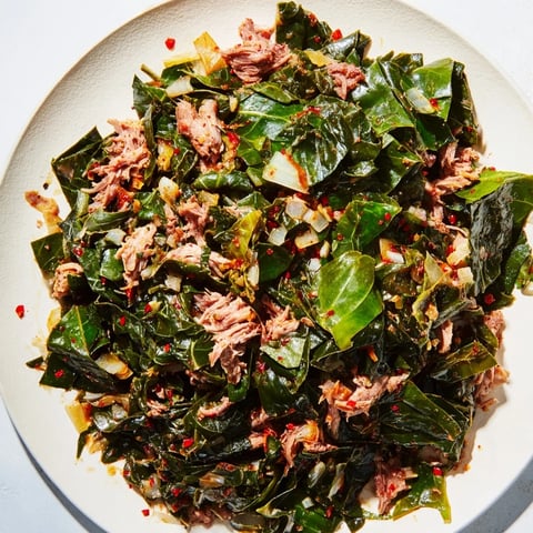 Steaming Southern-style collard greens with tender smoked turkey, a vibrant and savory side dish.