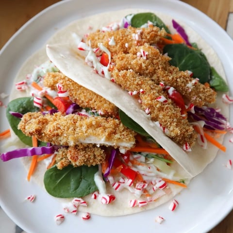 Crispy Candy Cane Crunch Chicken Veggie Wrap, filled with colorful vegetables, ready to eat.