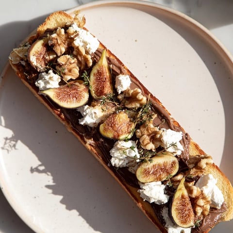 The Royal Tapestry appetizer with layers of pâté, sweet figs, and goat cheese, ready to serve.