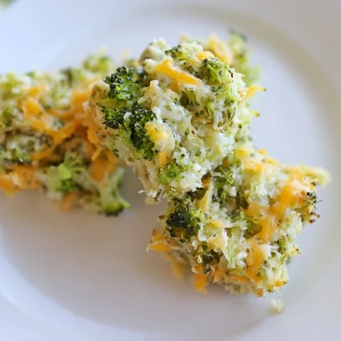 Steaming, golden Cheesy Broccoli Casserole Bites with melted cheese and delicious, soft broccoli florets.