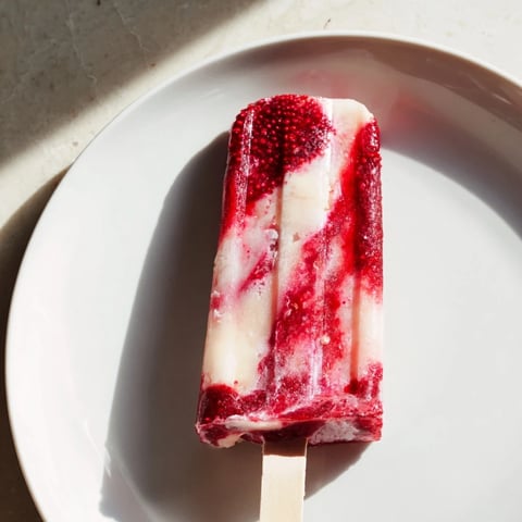 Creamy Raspberry Coconut Ice Pops, swirled with red berry goodness and creamy coconut, ready to eat!