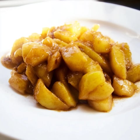 Slow cooker stewed apples bubbling gently, a cinnamon-infused breakfast or dessert topping.