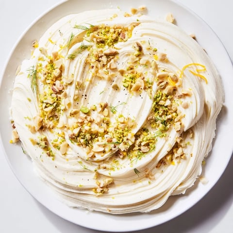 Creamy butter board charcuterie with toasted nuts, herbs, and lemon zest is a tasty appetizer.