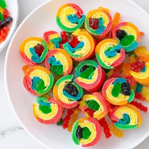 Vibrant Rainbow Candy Roll Ups, bursting with colorful gummy goodness, ready to be enjoyed as a sweet snack.