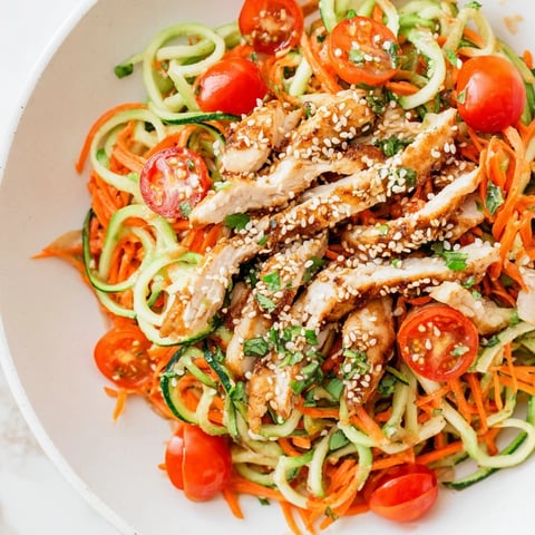 Vibrant Protein Cucumber Salad with grilled chicken, sesame dressing, and fresh cilantro, ready to eat.