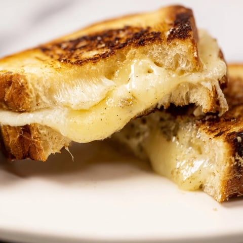 Golden, crispy sourdough slices sandwich melted Gruyère and aromatic truffle oil in this decadent Truffle Grilled Cheese.