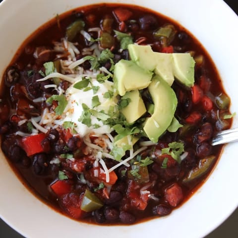 Rich and flavorful Spicy Black Bean Chili simmering in a pot, ready to serve.  