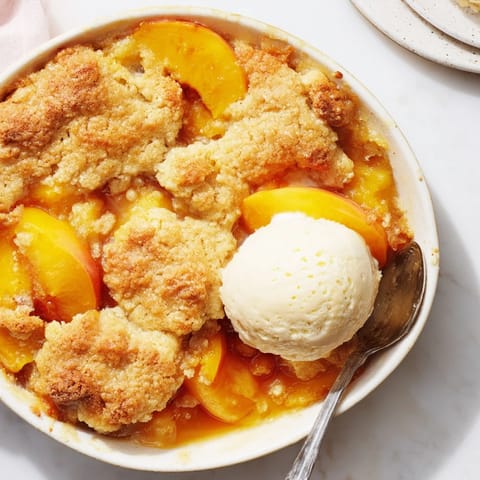 Golden, flaky Buttery Peach Cobbler fresh from the oven, bursting with juicy peaches.  