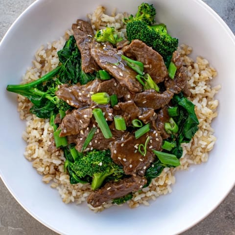 Close-up photo of steaming Slow-Cooker Beef & Broccoli: a complete, delicious, and easy Asian-inspired dish.