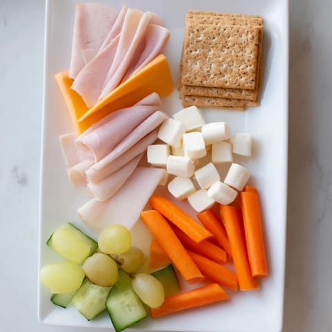 Fresh DIY Lunchables Tray includes ham, turkey, cheese, grapes, and crackers, a fun and easy lunch idea.