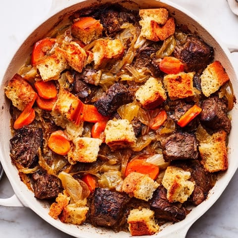 A close-up of a warm French Onion Pot Roast Casserole, showcasing tender beef and golden onions.