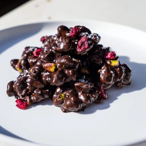 Golden, bite-sized Pistachio and Dried Cranberry Clusters on a parchment, ideal for sharing or gifting.