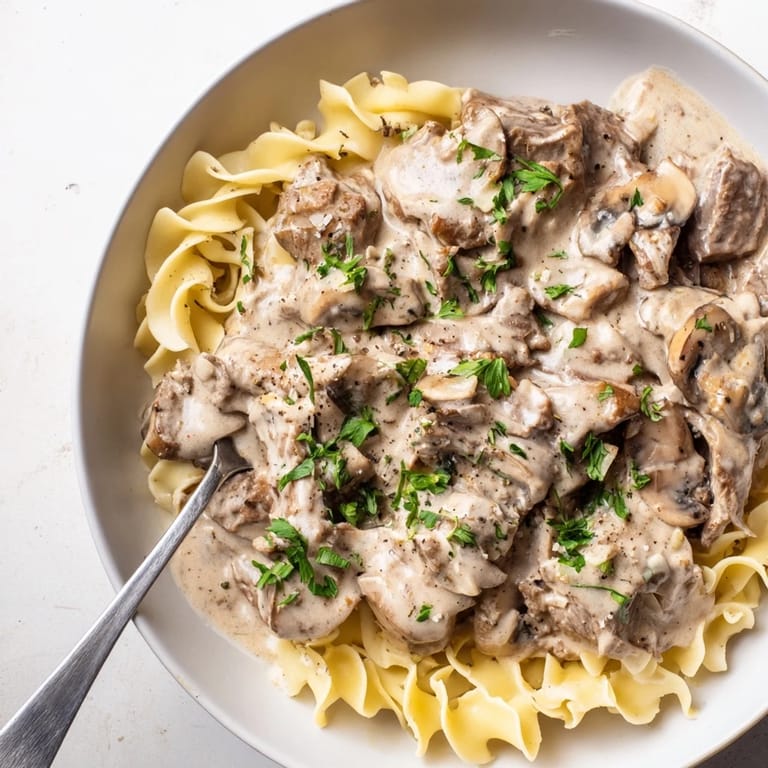 Comforting easy beef stroganoff featuring rich flavors of beef and sour cream.
