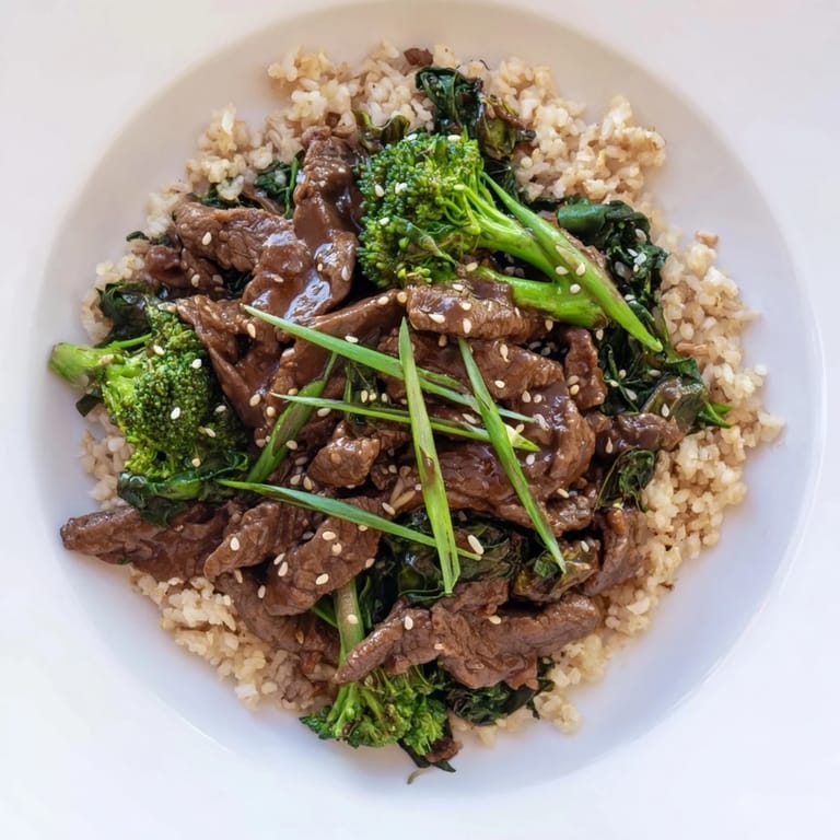A bowl of hearty Slow-Cooker Beef & Broccoli, garnished with scallions, perfect for a cozy weeknight dinner.