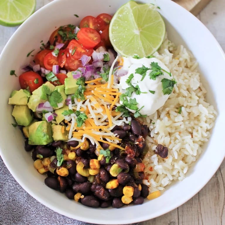 This healthy Rice, Bean, and Corn Burrito Bowl features a colorful array of fresh toppings, ready to enjoy.