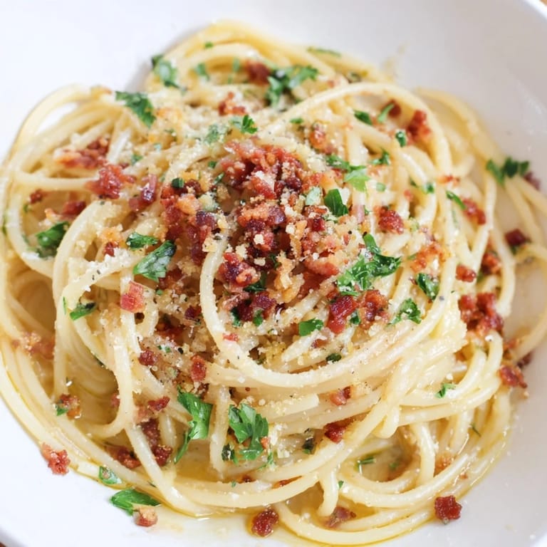 Creamy Garlic Butter Pasta, perfectly coated, topped with smoky bacon bits, ready to enjoy.