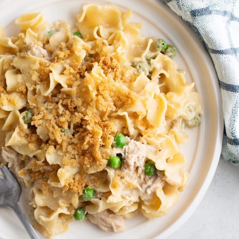 Bubbling, homemade Creamy Tuna Noodle Casserole, a comforting casserole with golden, buttery topping.