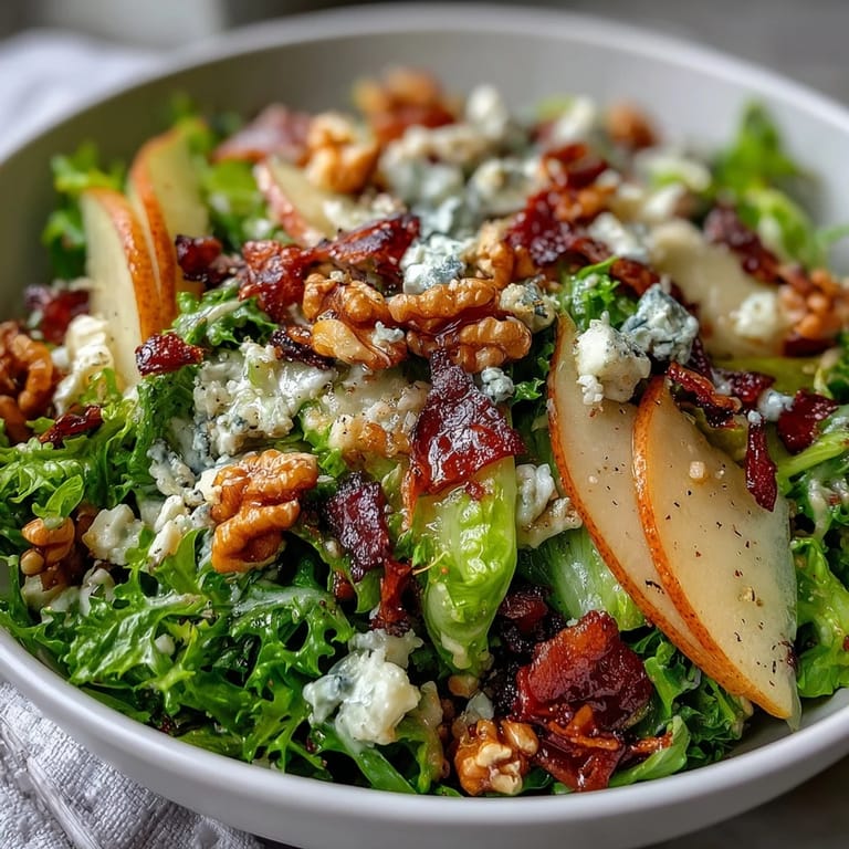 Tossed with a zesty vinaigrette, this Frisée Pear Blue Cheese Bowl features golden toasted walnuts and sweet pear wedges for a balanced bite.