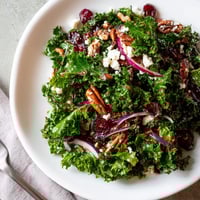 Warm Kale Salad With Maple Mustard Dressing: tender greens, sweet cranberries, crunchy nuts, served warmly.