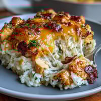 Golden Pineapple Chicken and Rice Casserole with bubbly melted cheese topping and juicy pineapple chunks.  