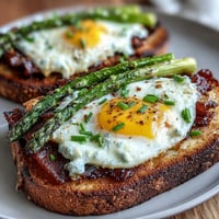 Asparagus and Egg Tartines with tender asparagus spears, creamy scrambled eggs, and fresh chives on golden toasted bread.