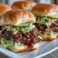 Tender BBQ baby shower brisket sliders with smoky pulled beef, tangy sauce, and crisp slaw on soft buns—ideal for parties.  