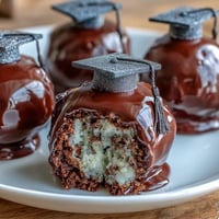 Colorful graduation cake pops in school colors, decorated with edible glitter and fondant caps, perfect for celebrating graduates.