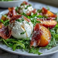Burrata and Peach Summer Salad with Prosciutto, featuring creamy cheese, sweet ripe peaches, and salty prosciutto over fresh greens.